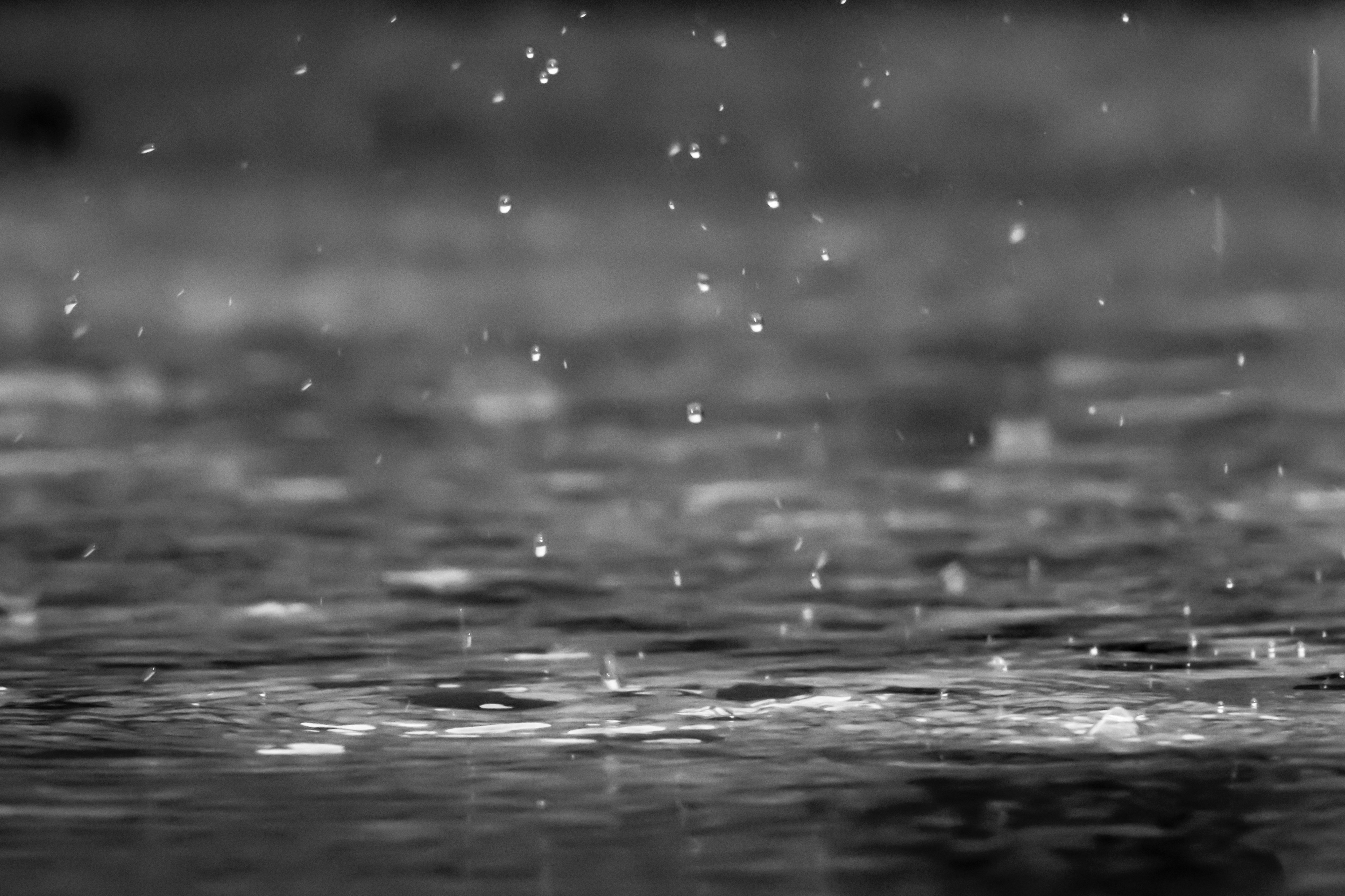 A photo of raindrops hitting the ground.